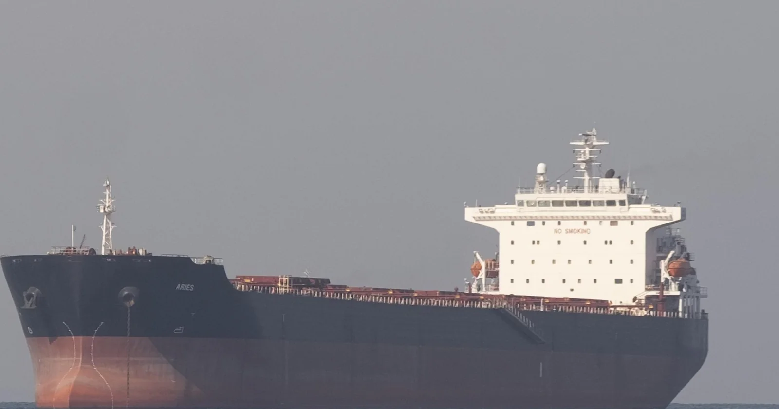 A bulk and product carrier under way, viewed toward the accommodation