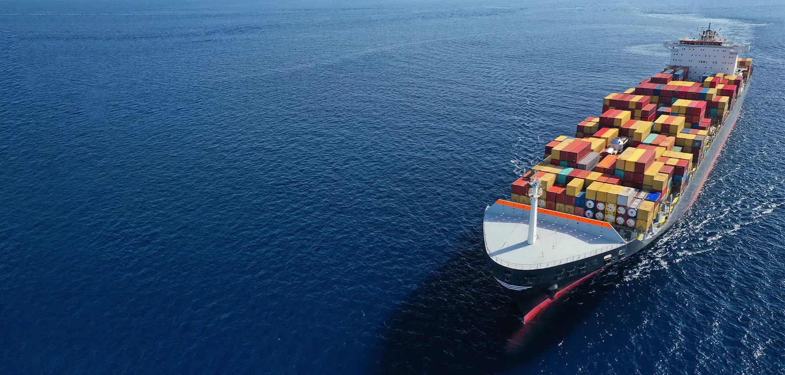 Aerial view of a laden container ship underway at sea